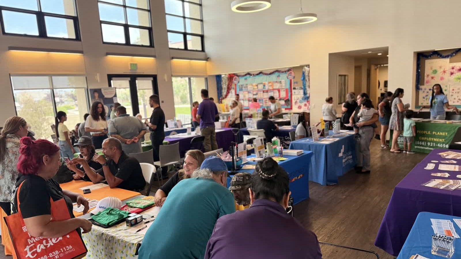 A CCE outreach table staffed by volunteers at a community event.