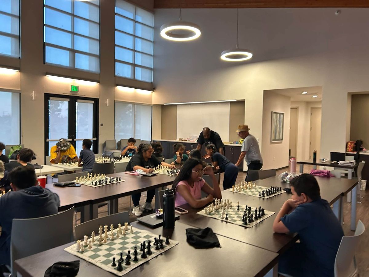 Rows of chess boards set out along tables across the Paradise Creek community hall.